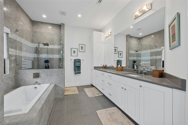 bathroom featuring vanity, tile patterned flooring, and separate shower and tub