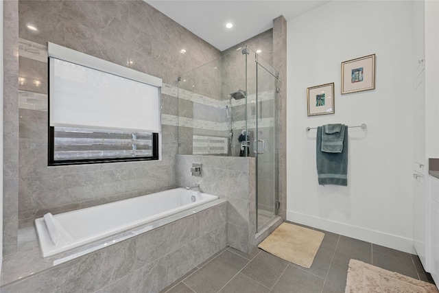 bathroom featuring tile patterned floors and separate shower and tub