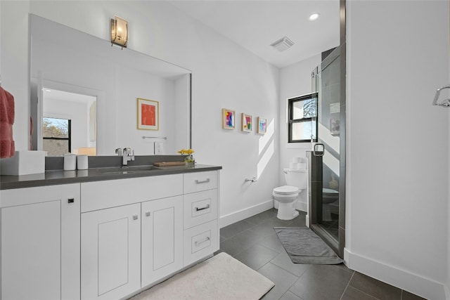 bathroom featuring tile patterned flooring, a wealth of natural light, and toilet