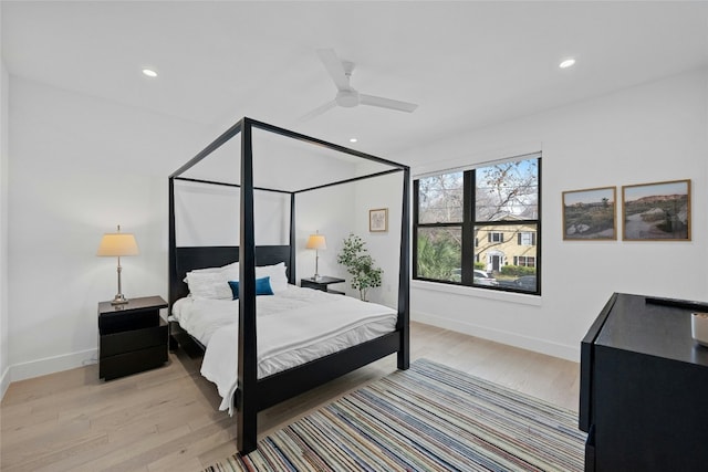 bedroom with light hardwood / wood-style flooring and ceiling fan