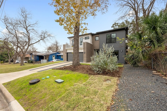 view of front of home with a garage and a front lawn