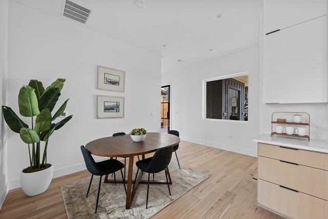 dining area featuring light wood-type flooring