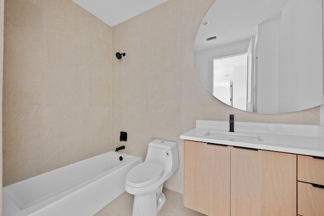 full bathroom with tiled shower / bath, tile walls, vanity, toilet, and tile patterned floors