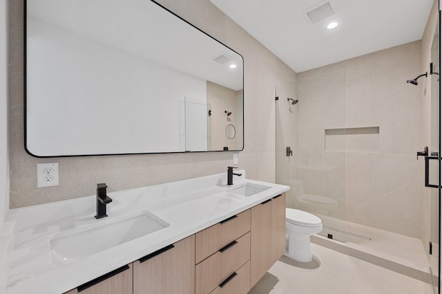 bathroom with vanity, an enclosed shower, and toilet