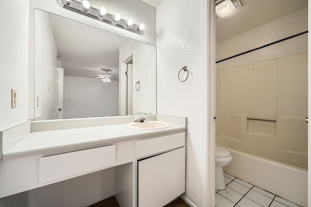 full bathroom featuring tub / shower combination, ceiling fan, tile patterned flooring, vanity, and toilet