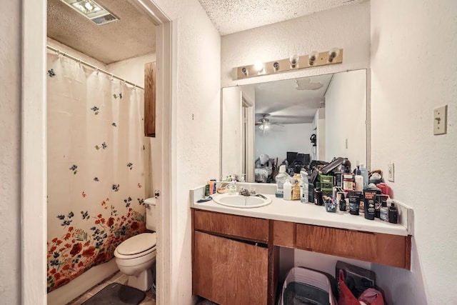 bathroom with vanity, toilet, a textured ceiling, and a shower with shower curtain