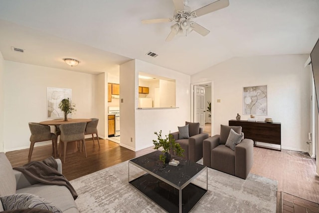 living room featuring wood-type flooring, lofted ceiling, and ceiling fan