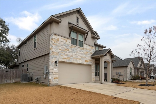 view of front facade featuring a garage and central AC