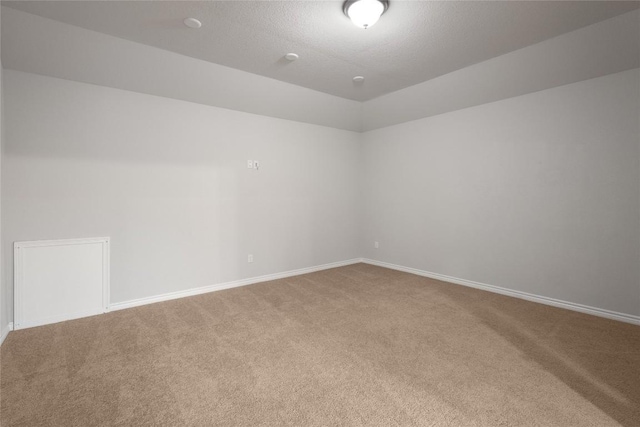 carpeted empty room featuring lofted ceiling