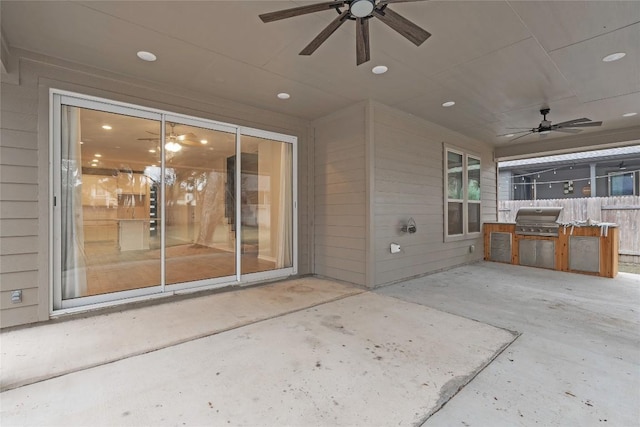 view of patio / terrace featuring a grill, ceiling fan, and an outdoor kitchen