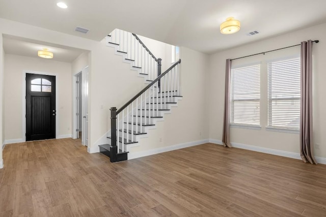 foyer entrance with light hardwood / wood-style floors