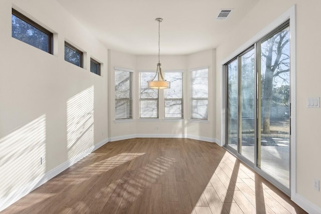 unfurnished dining area with hardwood / wood-style floors