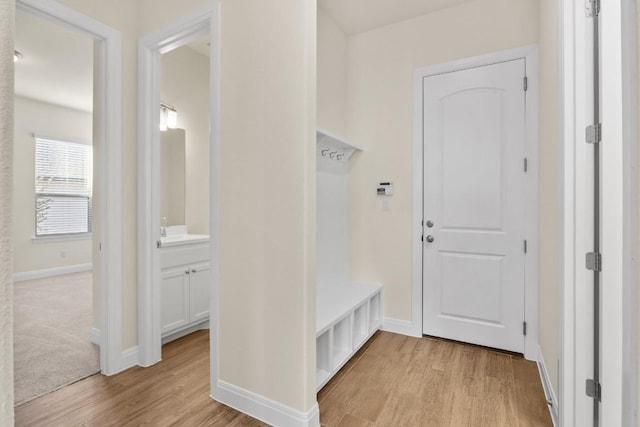 mudroom with light hardwood / wood-style floors