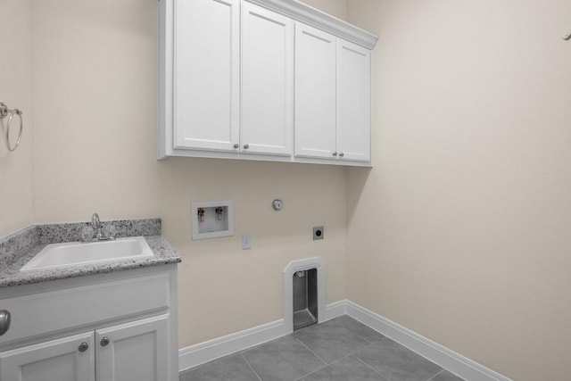 clothes washing area featuring sink, gas dryer hookup, cabinets, hookup for a washing machine, and hookup for an electric dryer