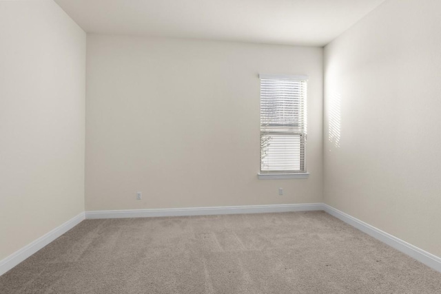 spare room featuring light colored carpet