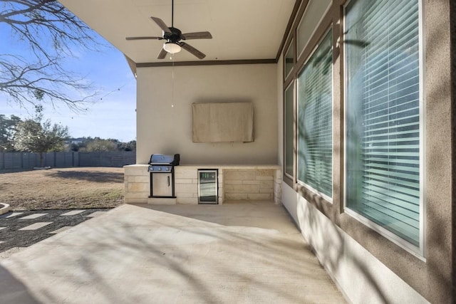 view of patio / terrace featuring ceiling fan, a grill, and beverage cooler