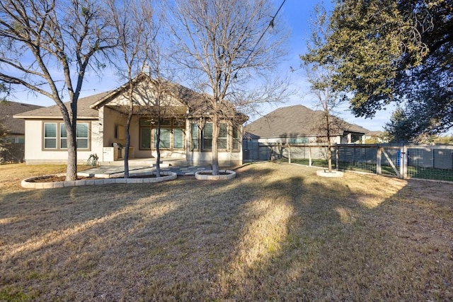 back of property with a patio and a lawn