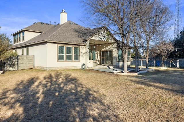 back of property featuring a patio and a lawn