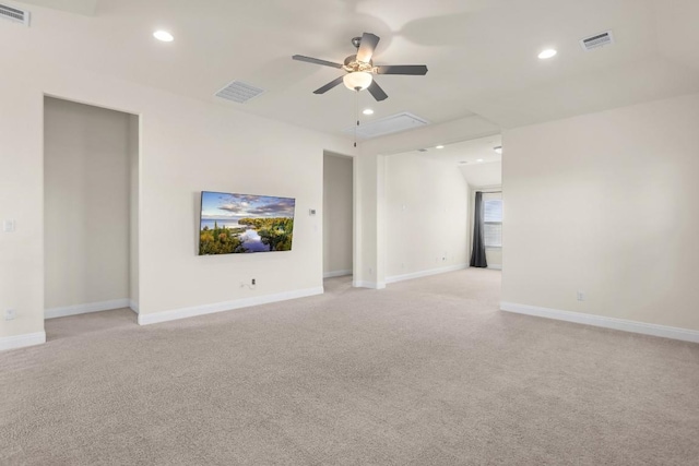 unfurnished living room with light colored carpet and ceiling fan