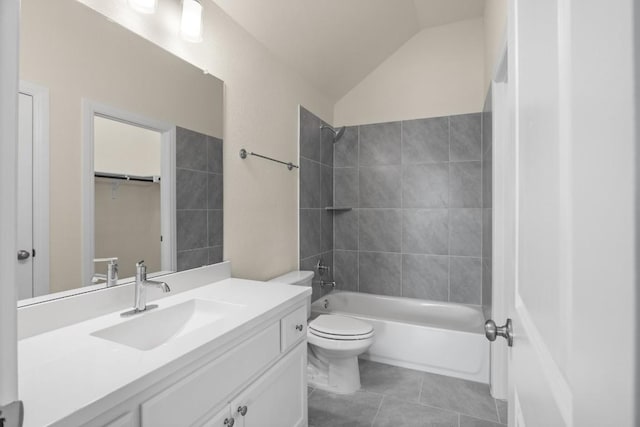 full bathroom featuring lofted ceiling, tile patterned flooring, vanity, tiled shower / bath, and toilet