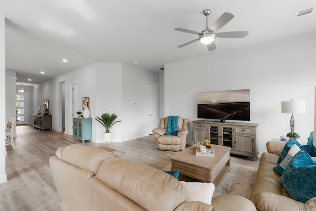 living room featuring ceiling fan and light hardwood / wood-style floors