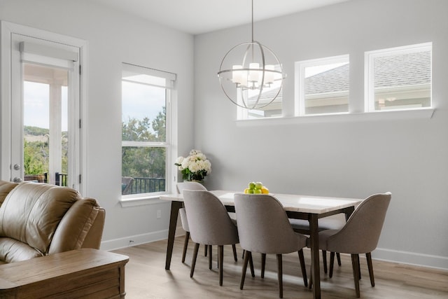 dining space featuring a notable chandelier and light hardwood / wood-style floors