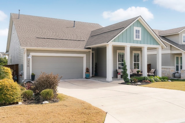 view of front facade featuring a porch and a garage