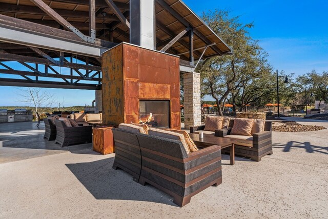 view of patio / terrace featuring an outdoor living space with a fireplace