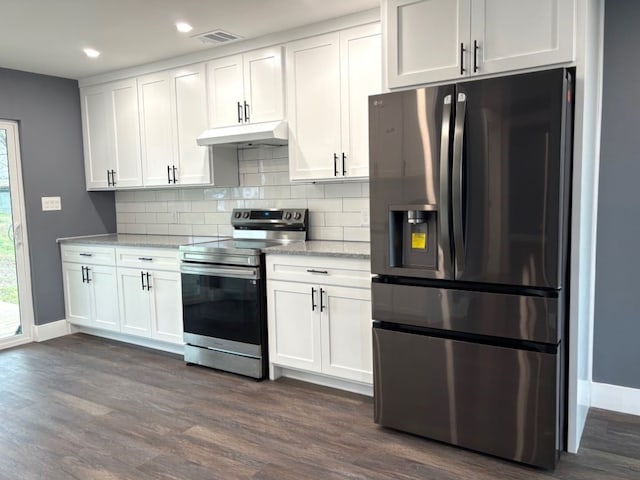 kitchen featuring dark wood-type flooring, stainless steel appliances, tasteful backsplash, and white cabinets