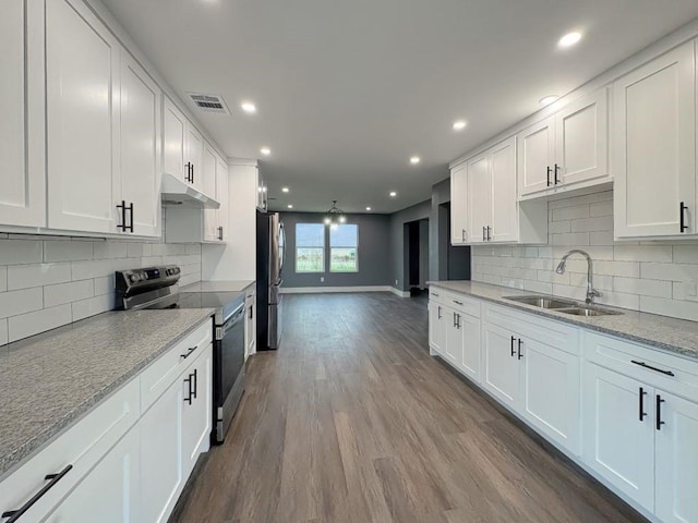 kitchen featuring stainless steel appliances, sink, and white cabinets