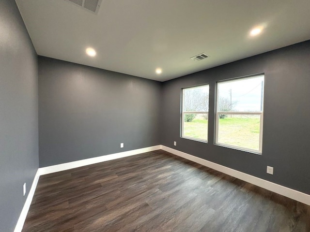 empty room featuring dark wood-type flooring