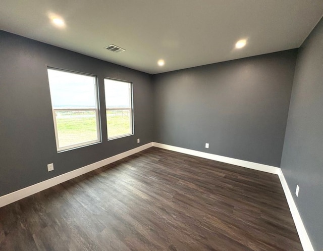 spare room featuring dark hardwood / wood-style flooring