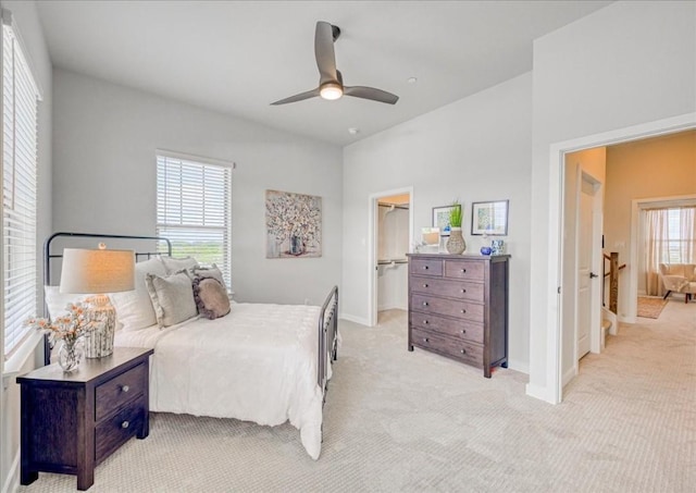 carpeted bedroom featuring a spacious closet, ceiling fan, and a closet