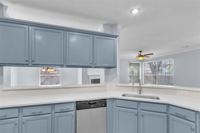 kitchen with dishwasher, sink, ceiling fan, kitchen peninsula, and blue cabinetry