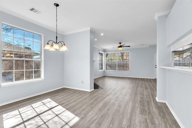 unfurnished dining area featuring ornamental molding, wood-type flooring, and ceiling fan with notable chandelier