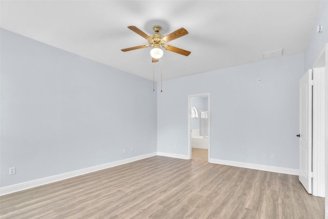 empty room featuring ceiling fan and light hardwood / wood-style floors