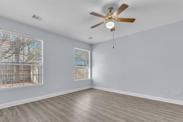 empty room featuring hardwood / wood-style flooring and ceiling fan