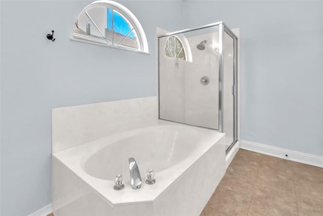 bathroom featuring tile patterned flooring and shower with separate bathtub