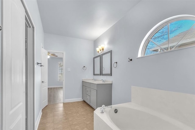 bathroom featuring vanity, a washtub, tile patterned flooring, and ceiling fan