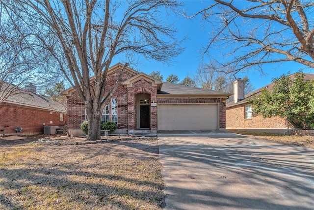 view of front of house with a garage and central air condition unit