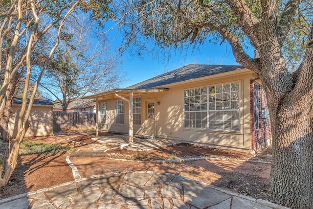 back of property with a patio