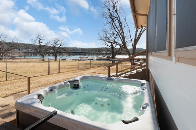 view of swimming pool with a hot tub