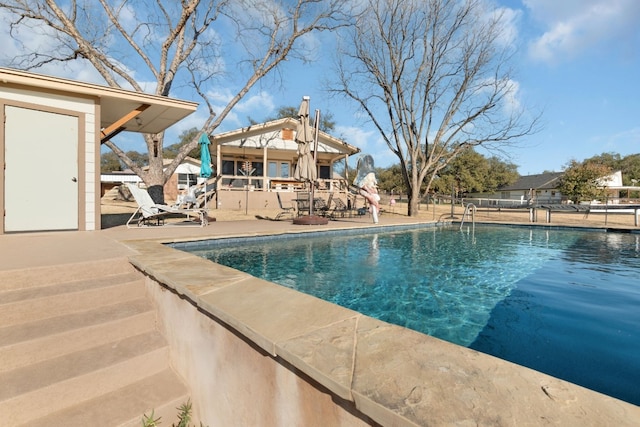 view of swimming pool with a patio area