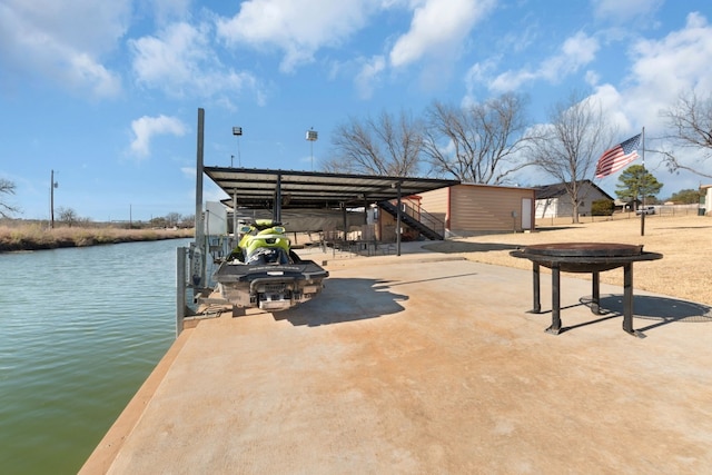 view of patio / terrace with a water view and a boat dock