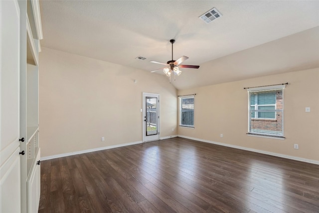 unfurnished room with dark wood-type flooring, ceiling fan, vaulted ceiling, and a wealth of natural light