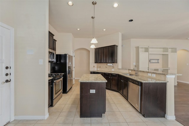 kitchen with dark brown cabinetry, sink, a kitchen island, pendant lighting, and stainless steel appliances