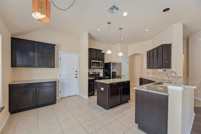 kitchen featuring sink, decorative light fixtures, a center island, appliances with stainless steel finishes, and kitchen peninsula