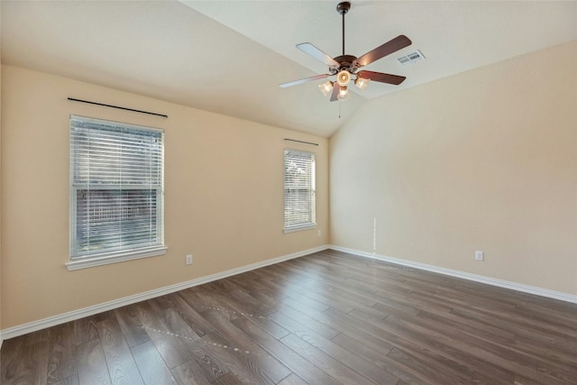 empty room featuring dark wood-type flooring, ceiling fan, and vaulted ceiling