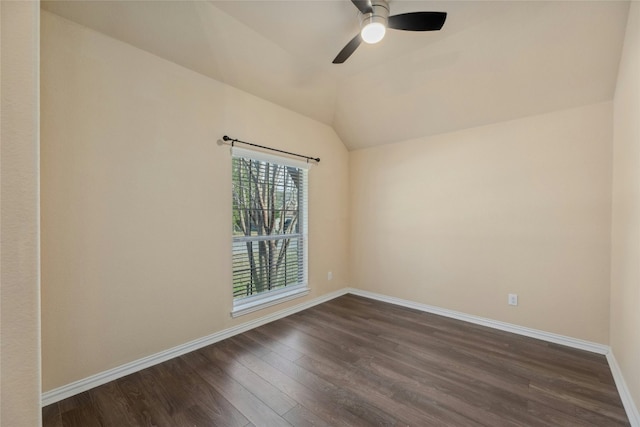 empty room featuring ceiling fan, dark hardwood / wood-style floors, and vaulted ceiling