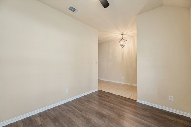 unfurnished room with wood-type flooring and ceiling fan with notable chandelier